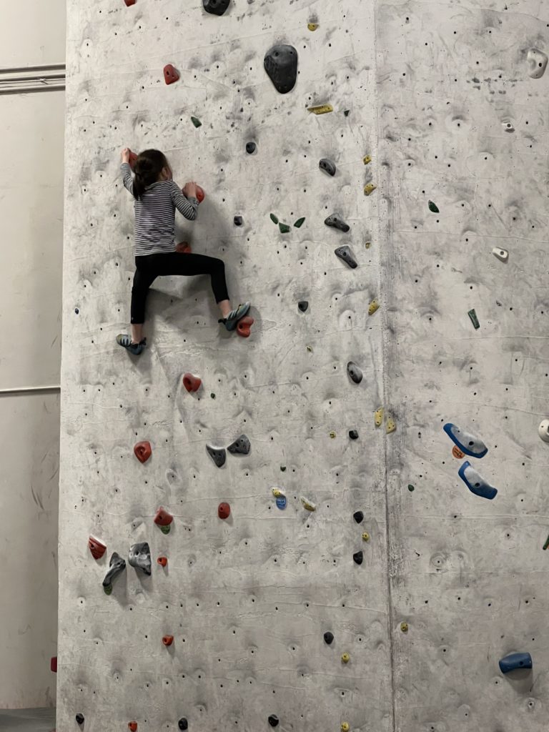 kid on a bouldering wall