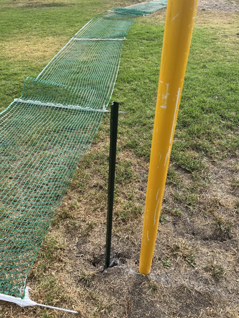 wiffle ball field foul pole being installed