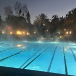 a pool in the early morning with steam coming off