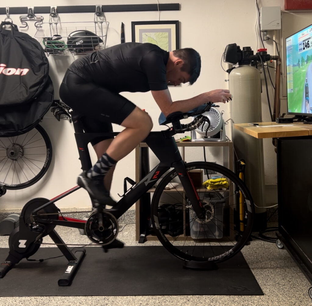 Riding in a pain cave in the garage on an indoor zwift trainer